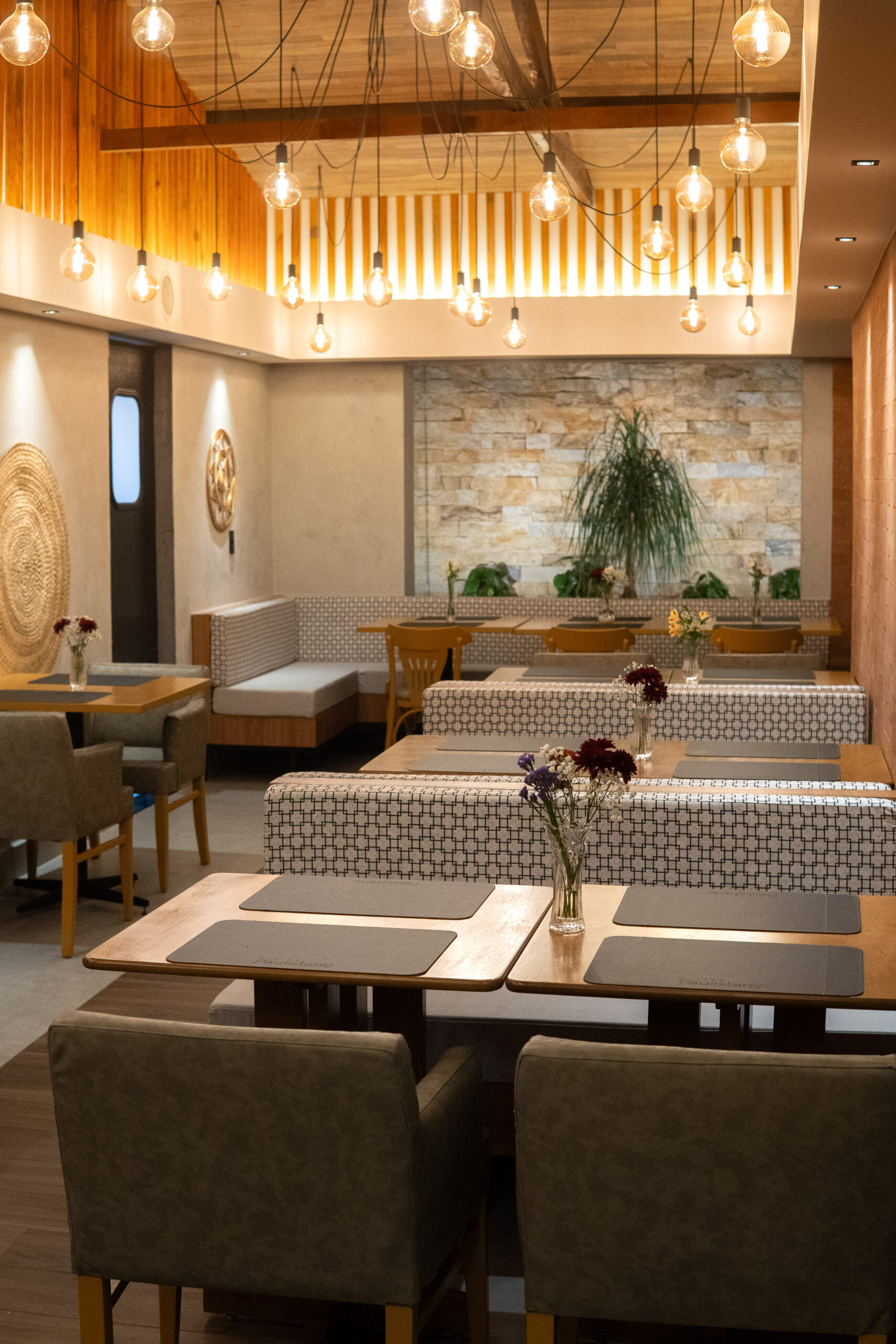 Interior view of a candle-lit bistro with wooden tables